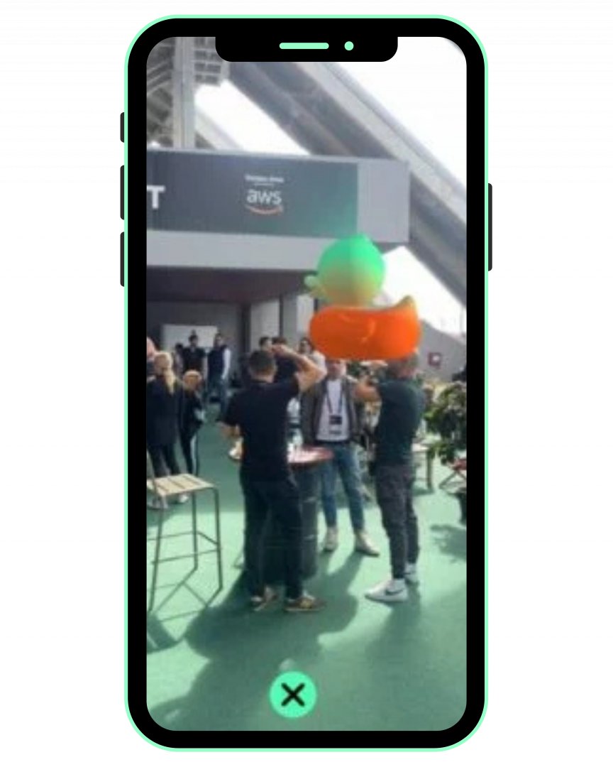 Conference attendees using mobile devices to view a 3D AR duck through their phones.